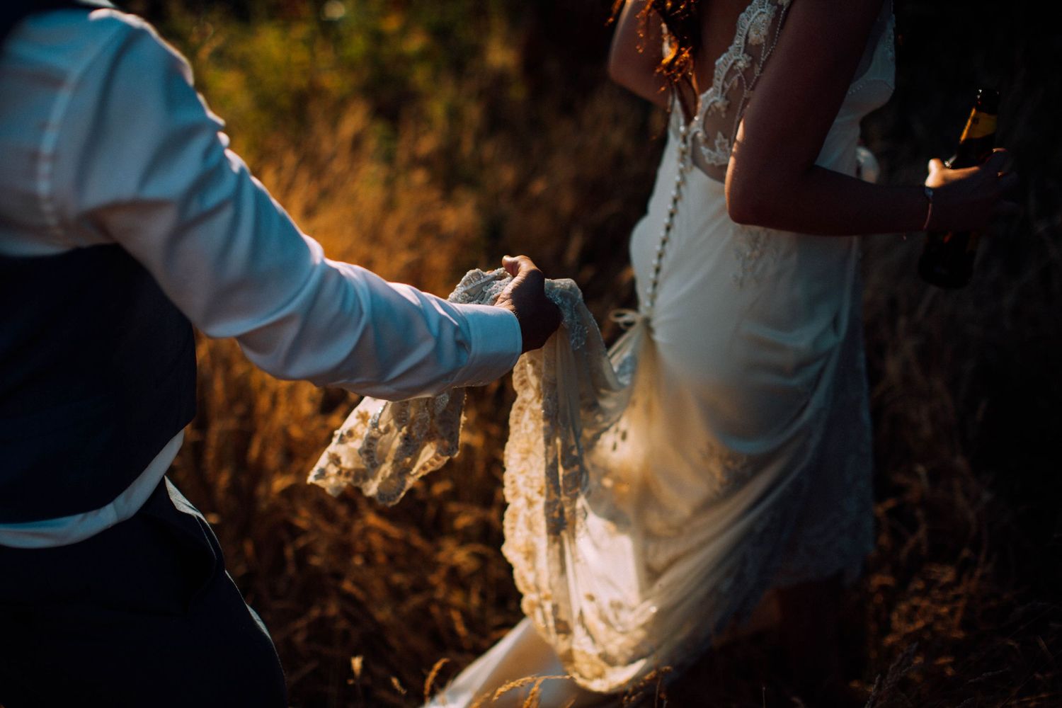 Artistic silhouette of wedding couple in dramatic lighting.