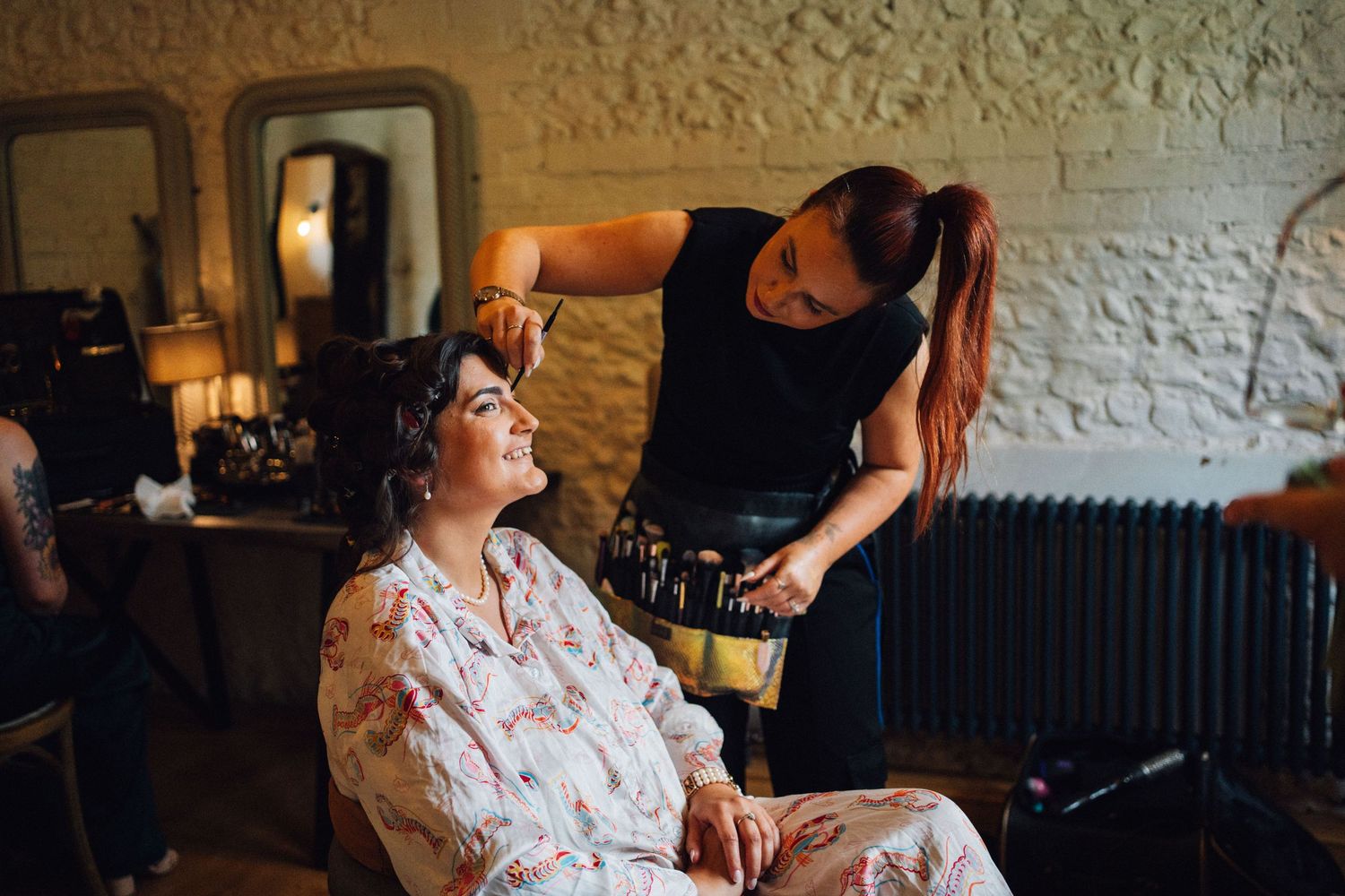 A series of candid moments in a dimly lit interior space with vintage brick walls and warm lighting.