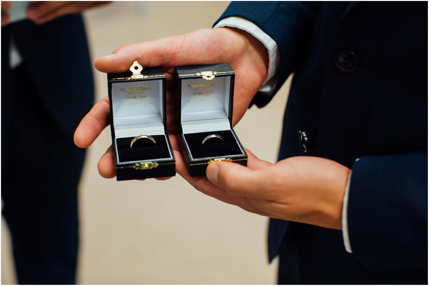 Close-up shot of wedding rings being displayed in a small black box.