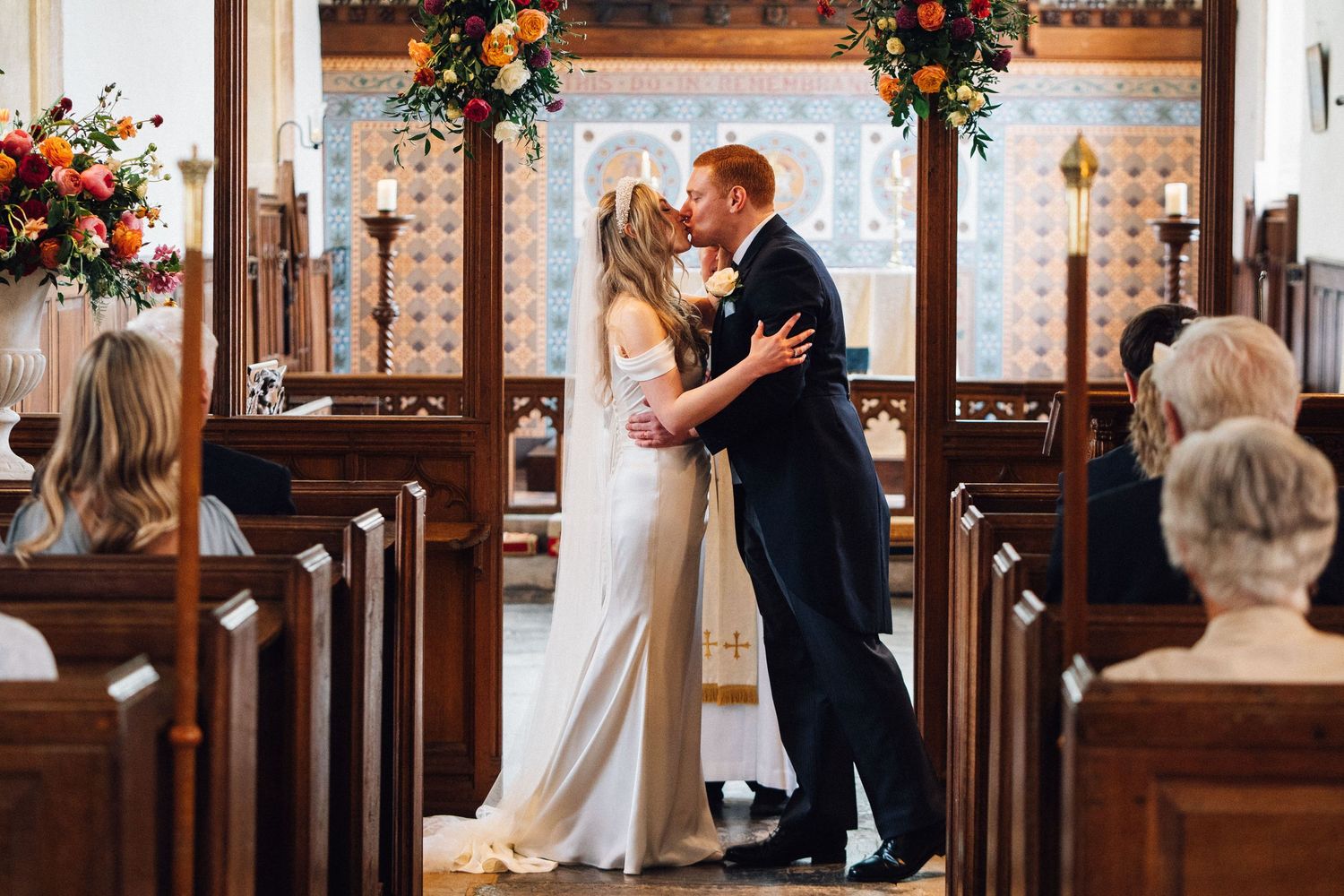 A romantic wedding ceremony sequence showing multiple angles of a couple embracing in an elegant church setting.