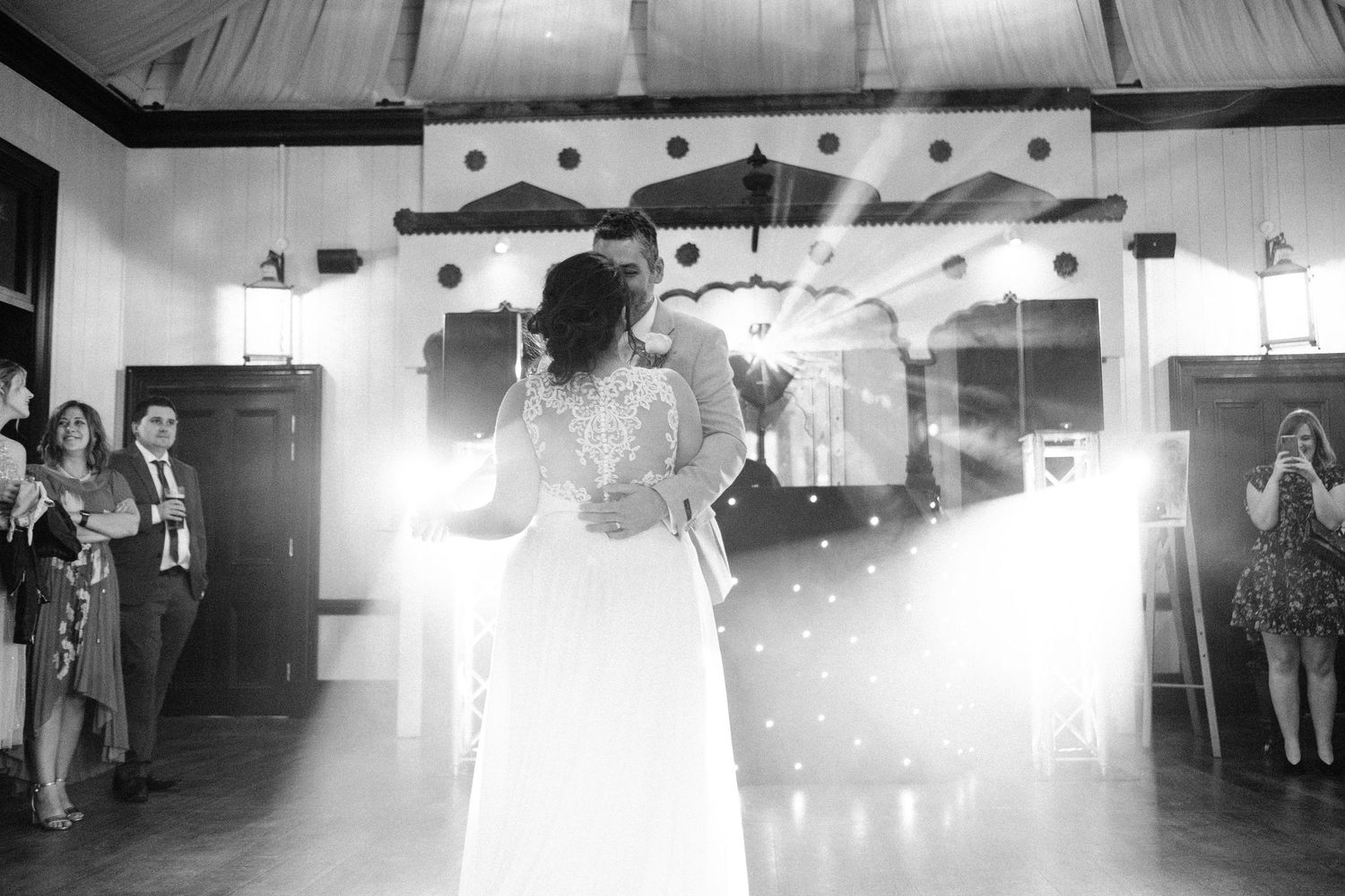 Wedding venue interior with dramatic lighting and smoke effects creating atmosphere.