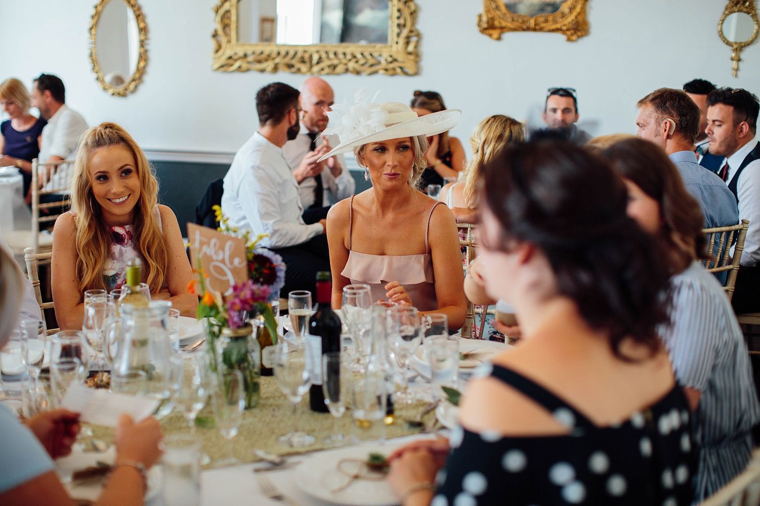 Candid moments captured during a wedding reception as guests dine and celebrate.