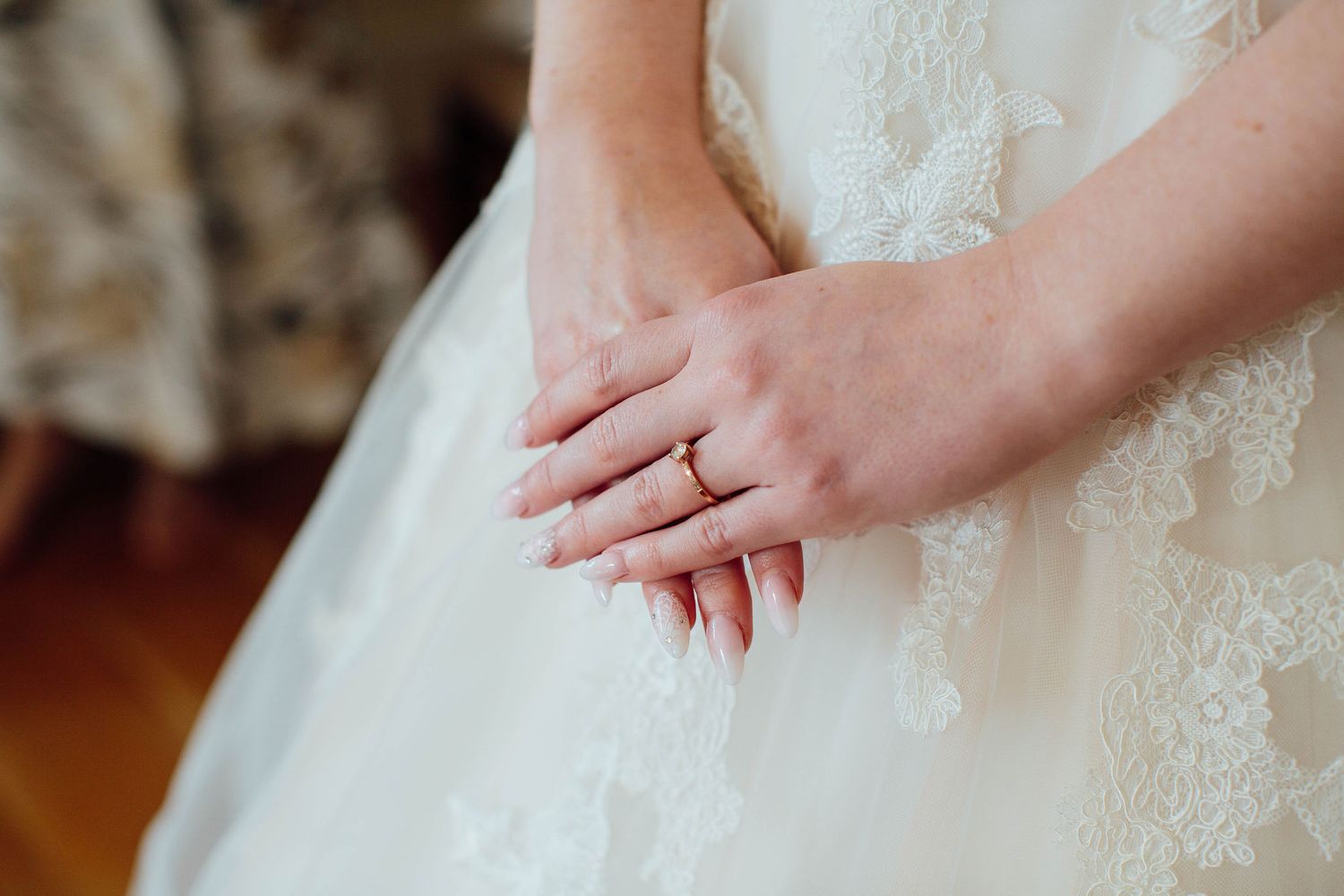 Close-up details of delicate lace on a white wedding dress.