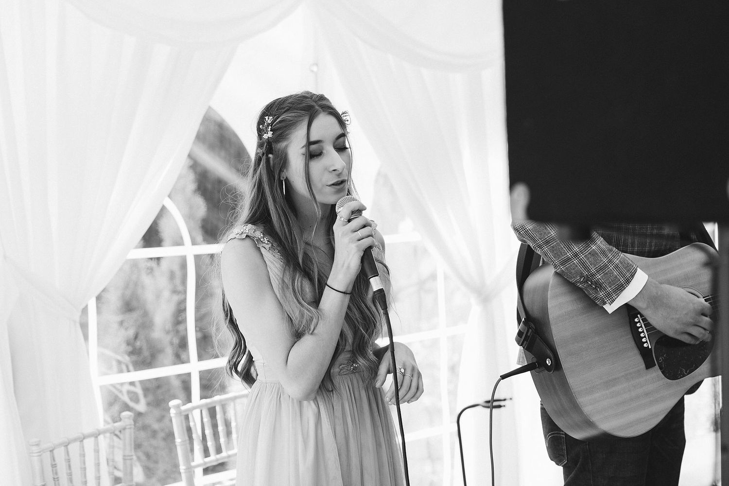Black and white emotional wedding moments captured during speeches.