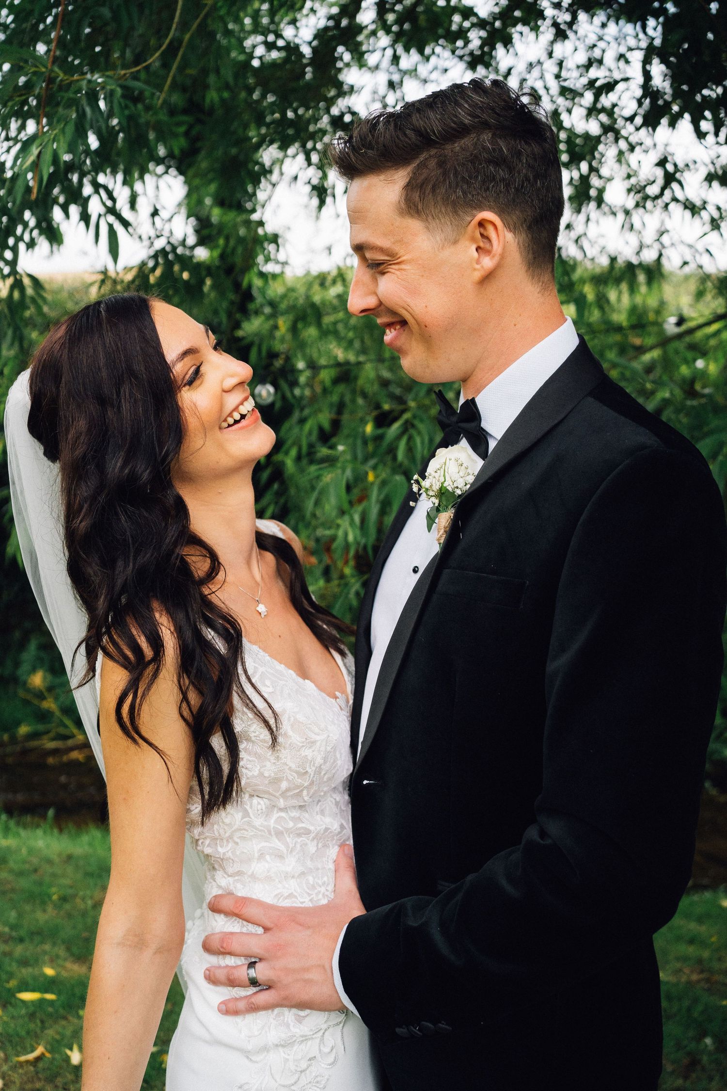 A romantic wedding moment captured in a garden setting with lush greenery.