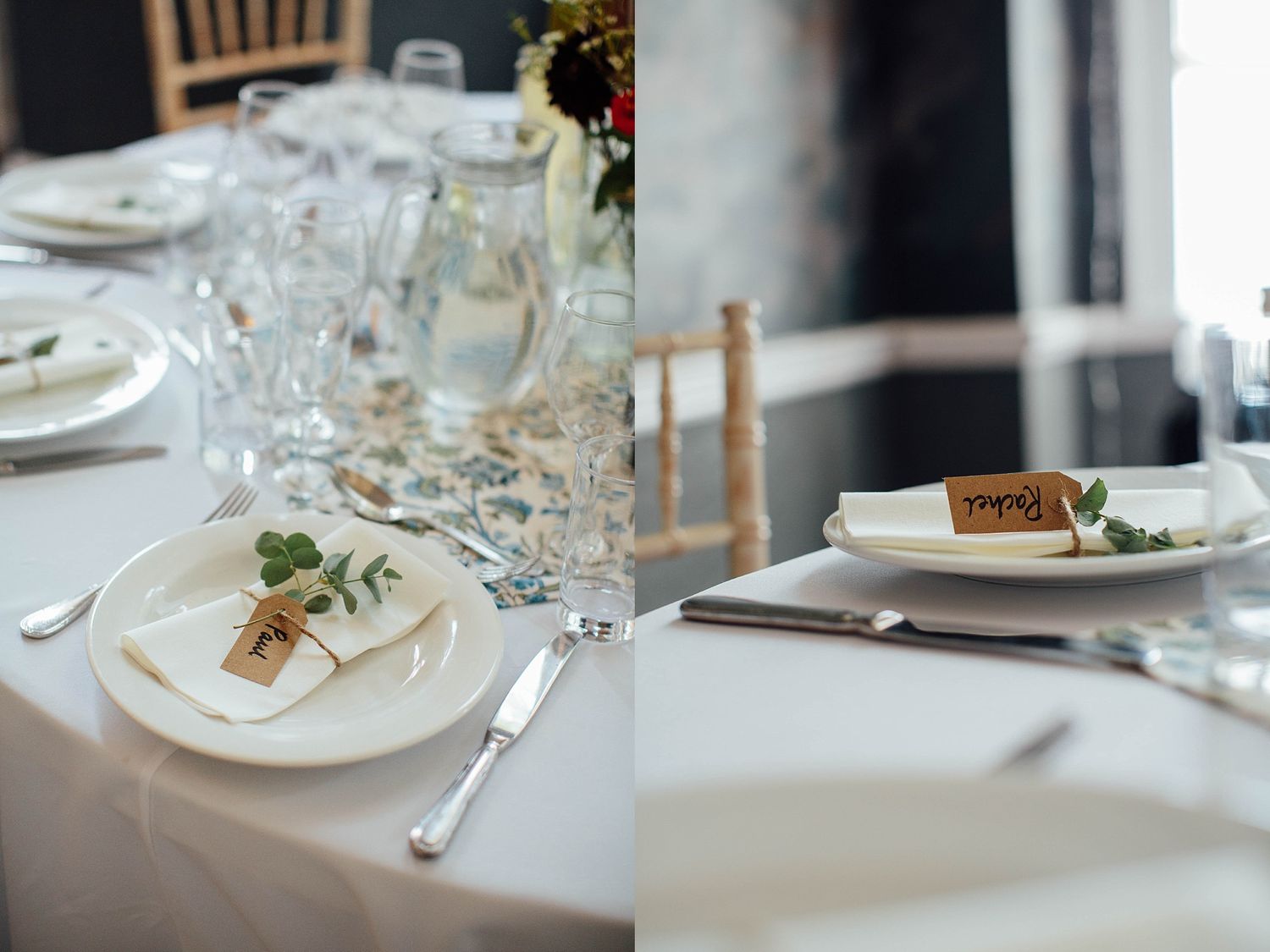 Elegant white place settings with name cards and greenery at formal event.
