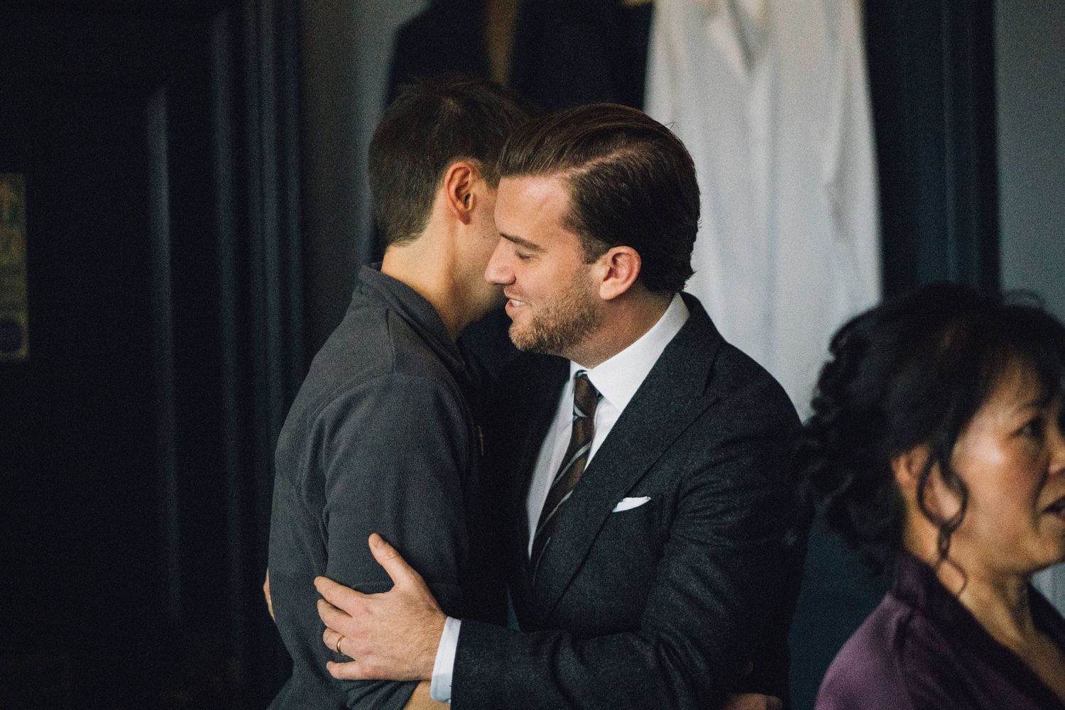 Intimate wedding moments captured in dramatic lighting against dark backgrounds.