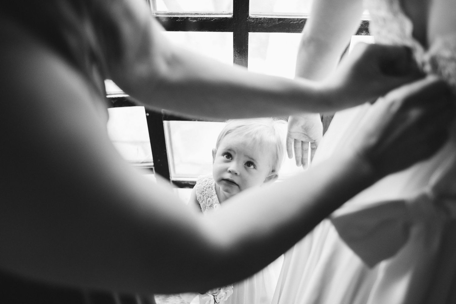 Black and white artistic photo showing hands in motion during a celebration.