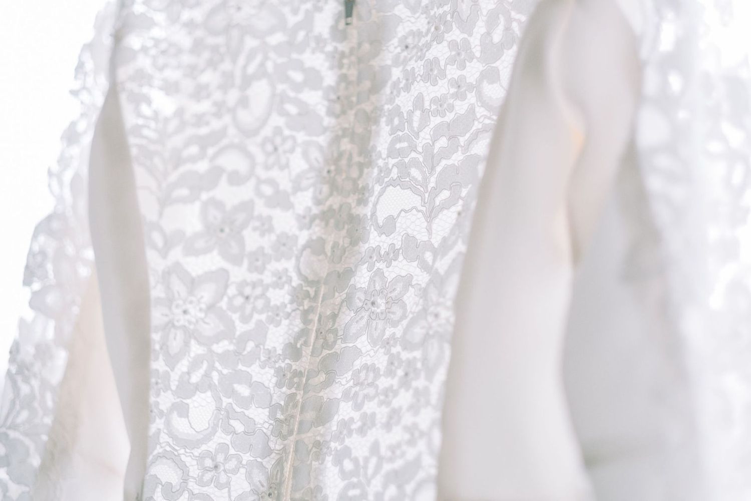 White lace curtains creating an elegant backdrop with delicate floral patterns.