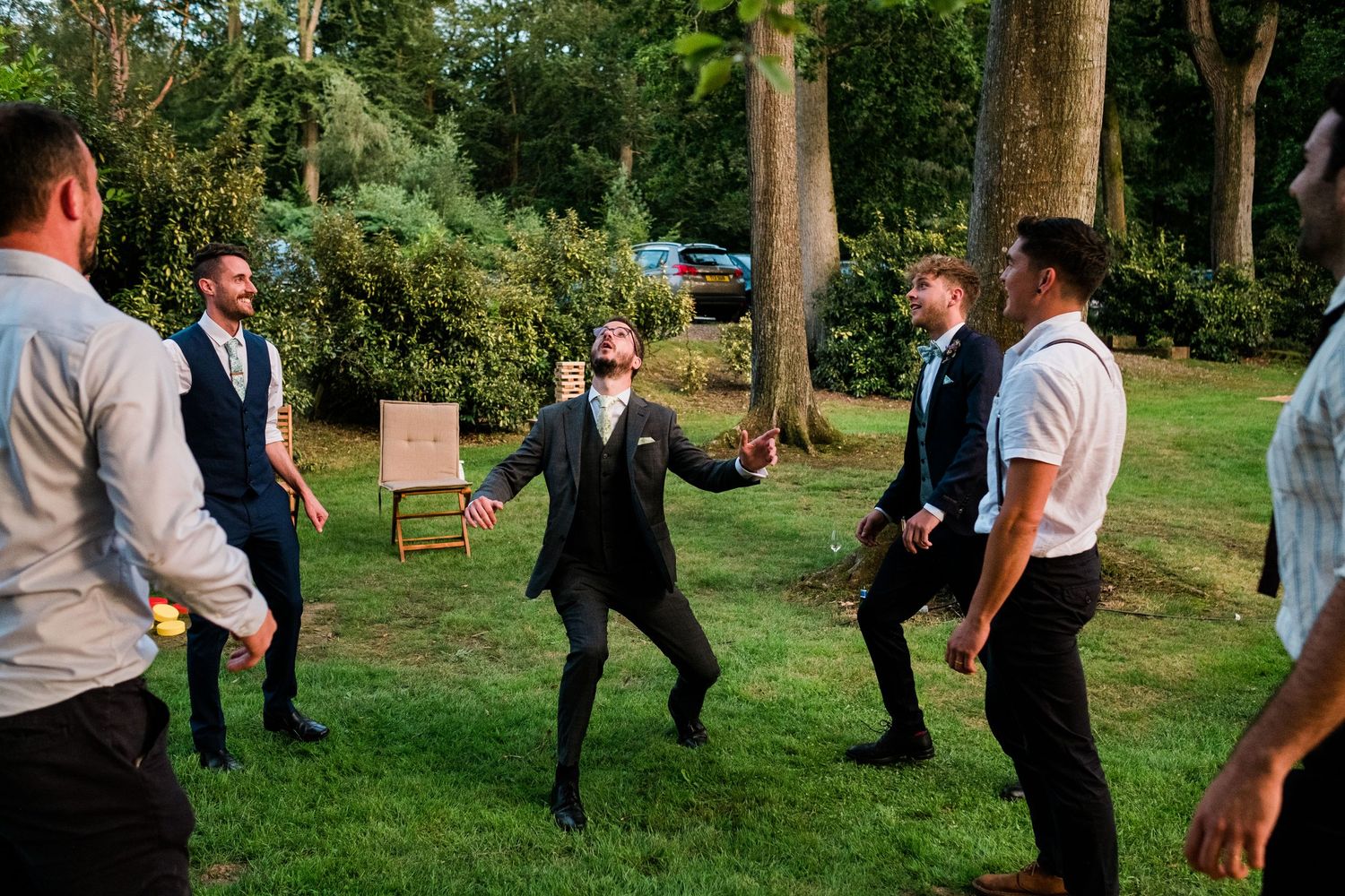 Wedding guests playing outdoor lawn games during a casual reception celebration.