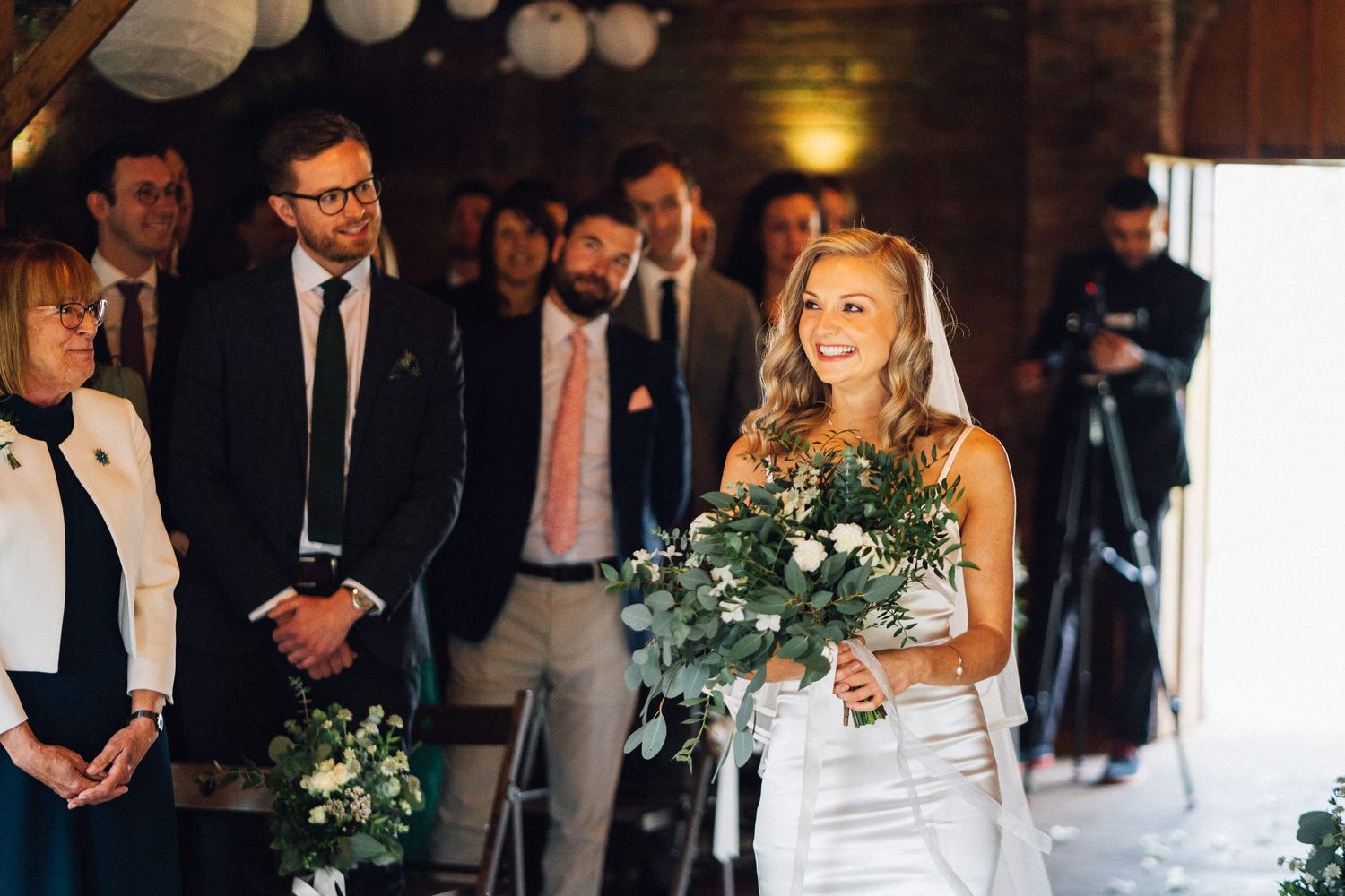 Wedding reception guests enjoy a festive celebration with dancing, dining and floral decor in an elegant venue.