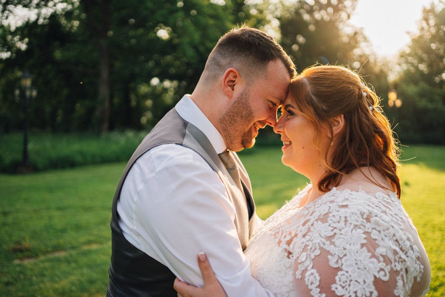 Romantic sunset moment captured in a garden setting during wedding celebrations.