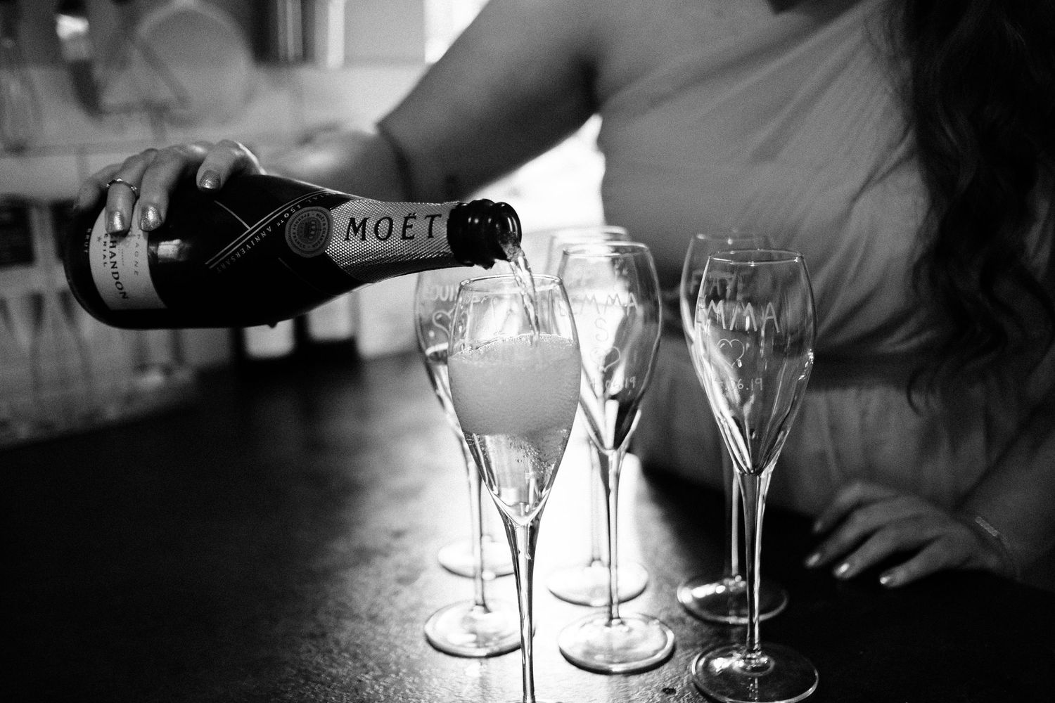 Moet champagne being poured into crystal flutes at a celebration.