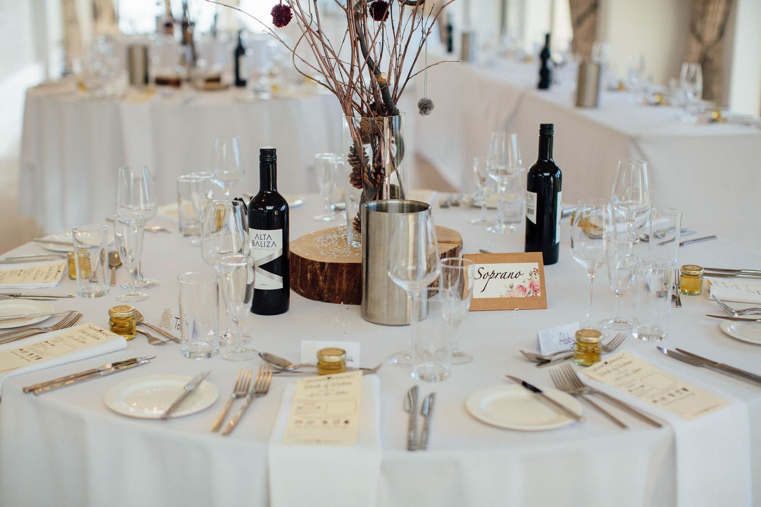 Elegant table settings with wine glasses and place settings at a formal reception.