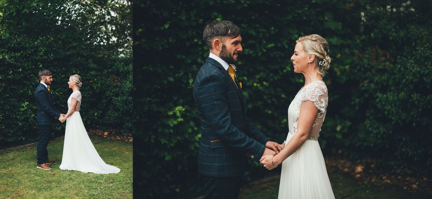 Outdoor wedding ceremony scene with natural greenery in the background.