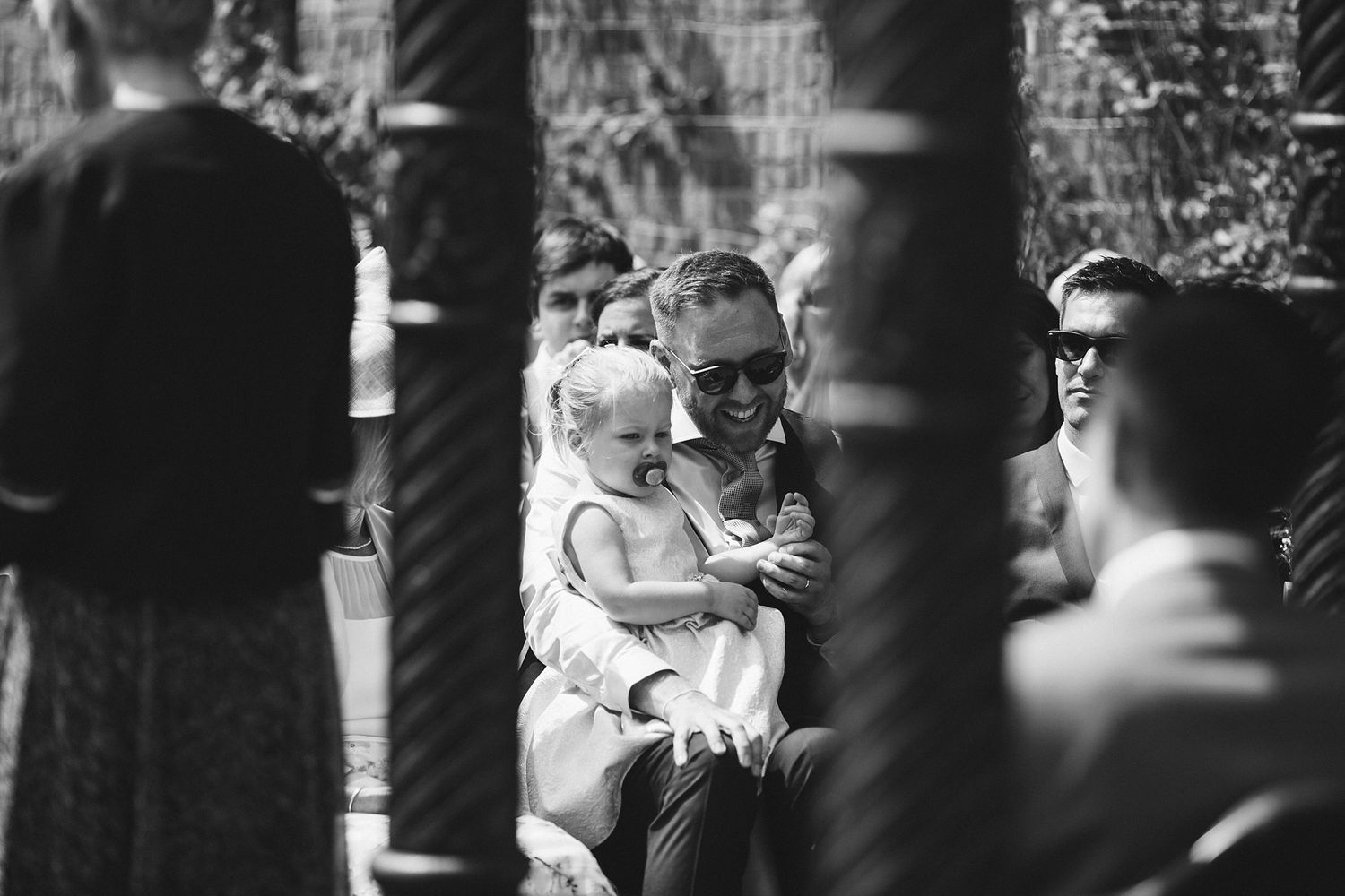 Black and white candid shots of wedding ceremony reactions.