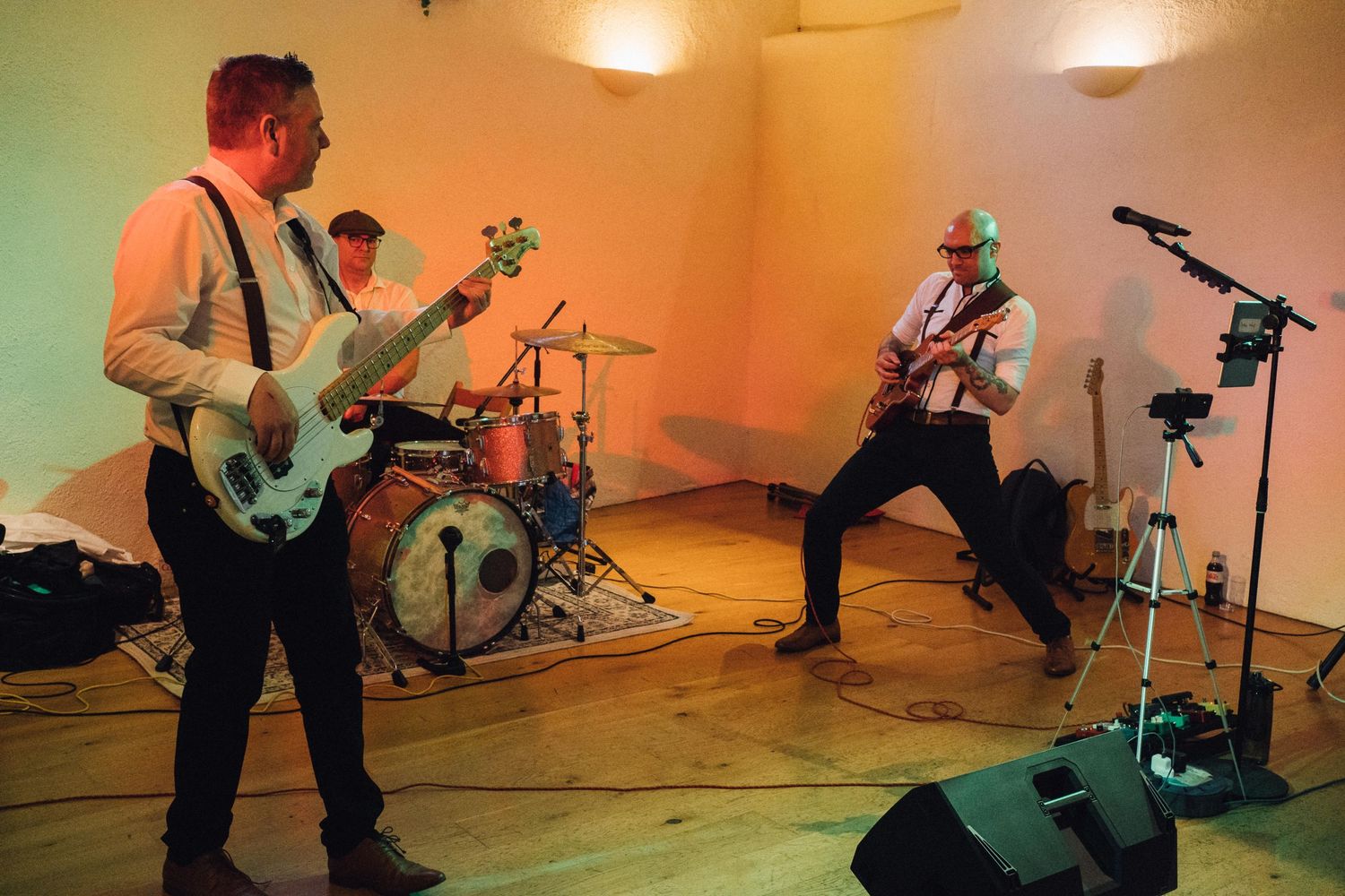 Live band performing at wedding reception with colored lighting effects.