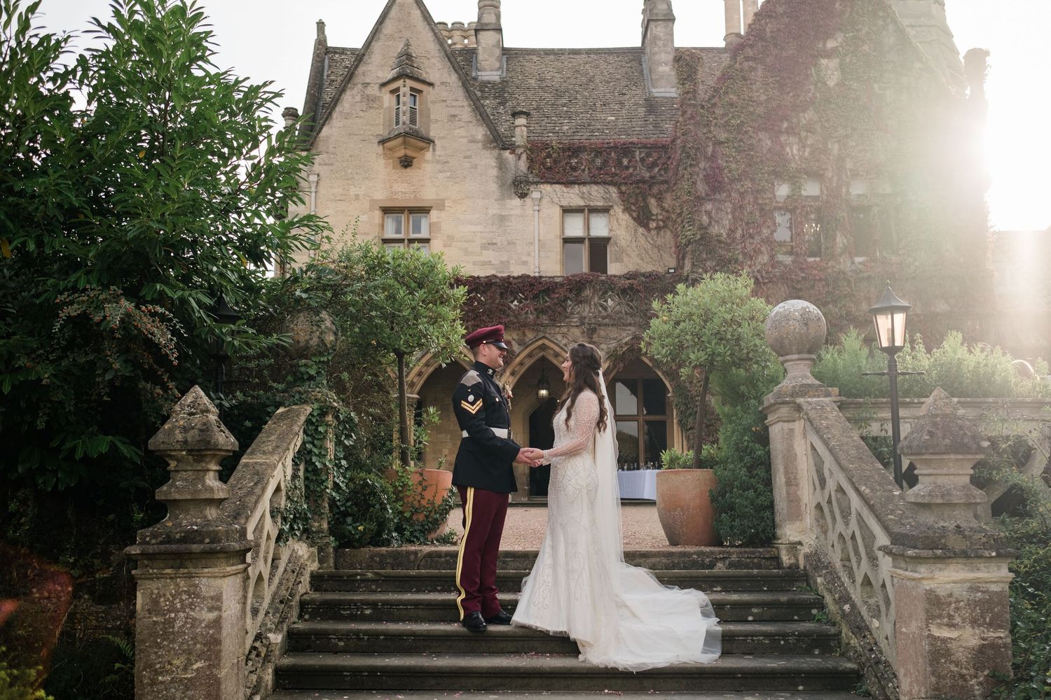 Romantic wedding photos at a historic stone building during golden hour.