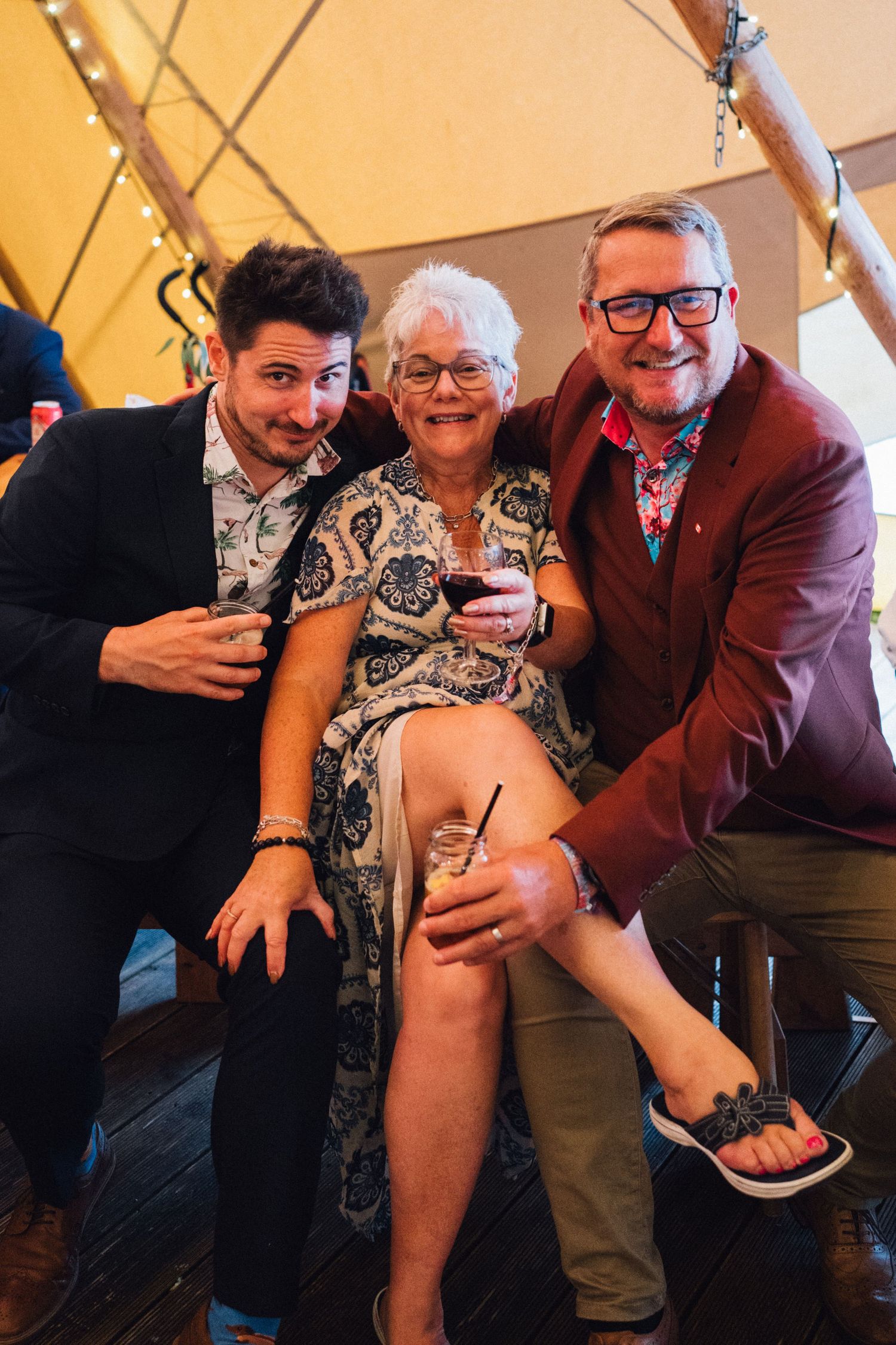 Guests sharing drinks and laughter during an evening celebration.