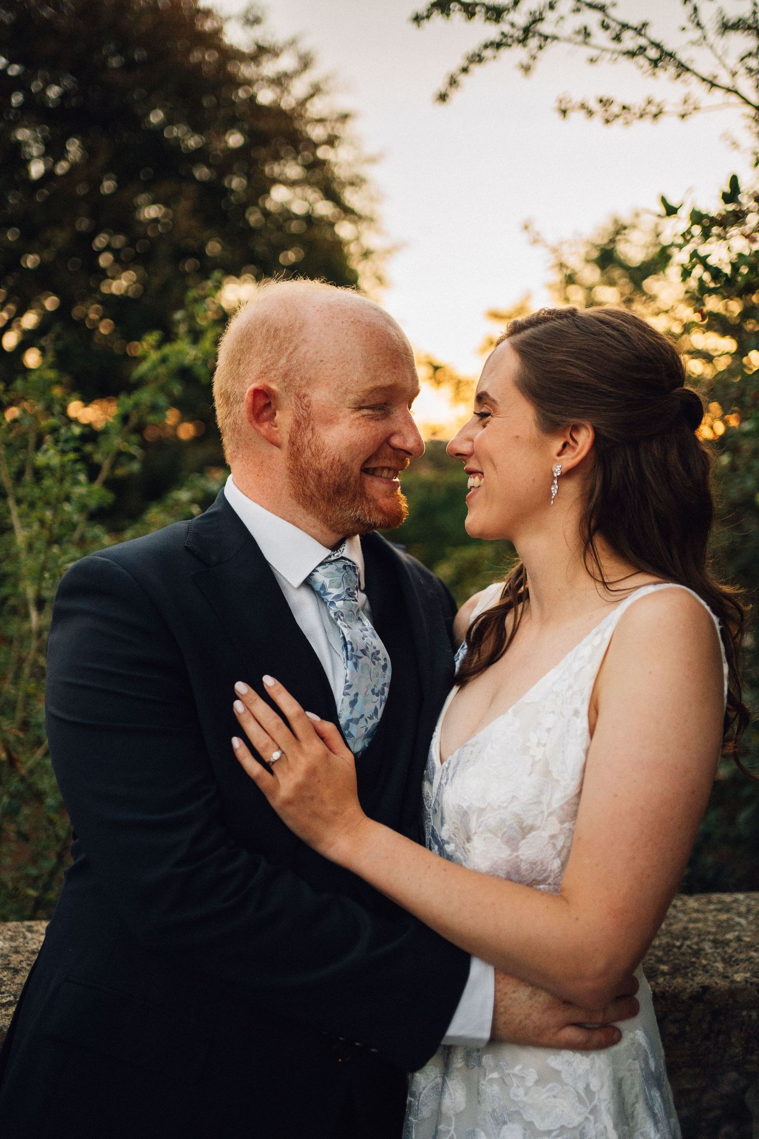 Romantic sunset wedding portraits captured in a garden setting.