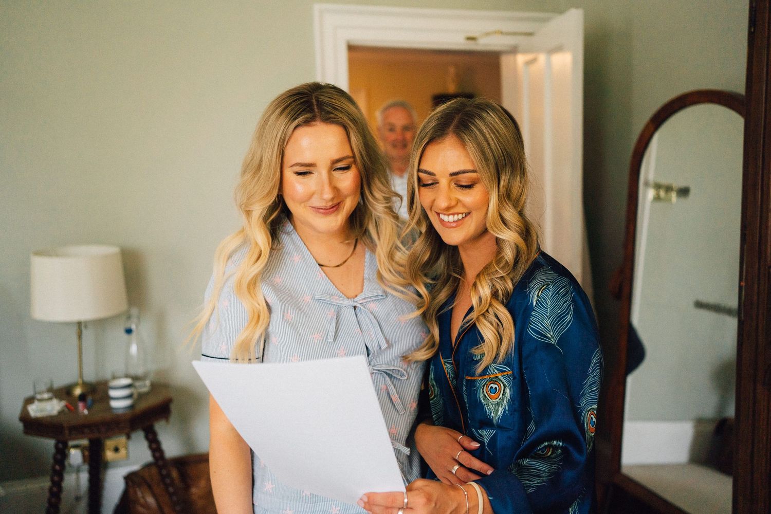 Wedding preparation scene with light blue and white color scheme in a bright room.