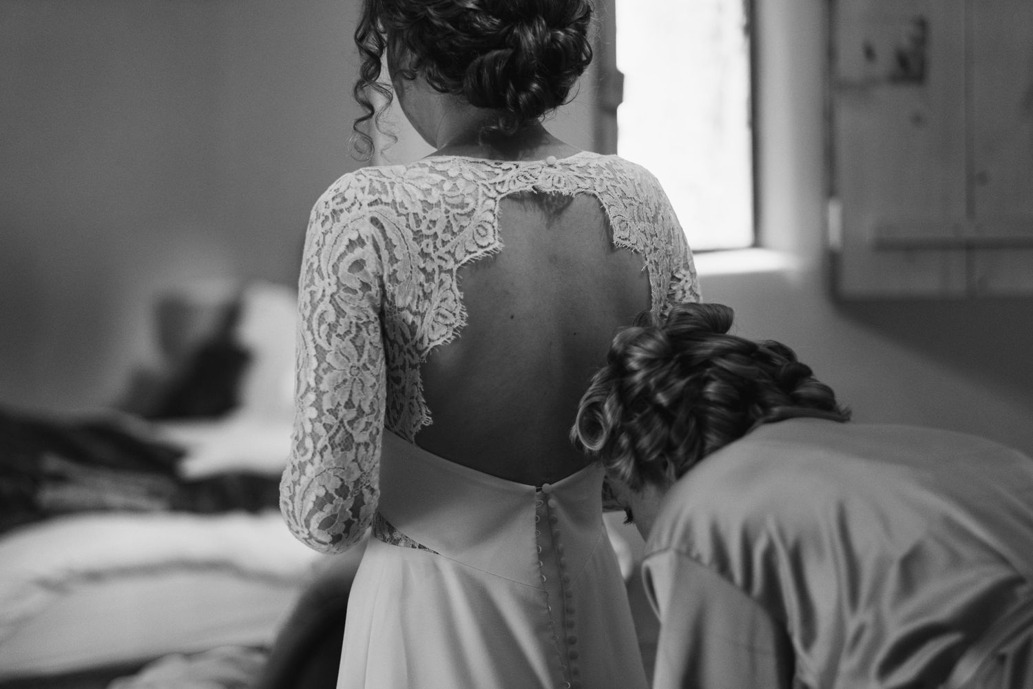 Back view of an elegant lace wedding dress with an open back design.