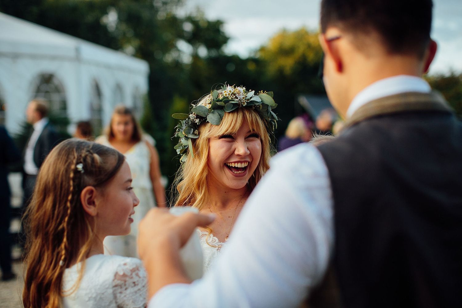 Wedding party celebrating outdoors on a sunny day.