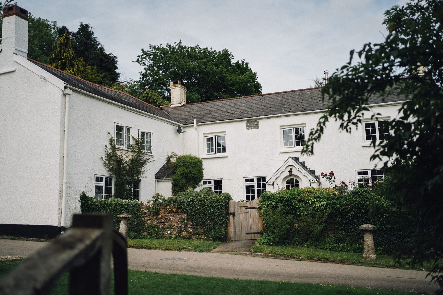 White country house with traditional architecture and landscaped gardens.
