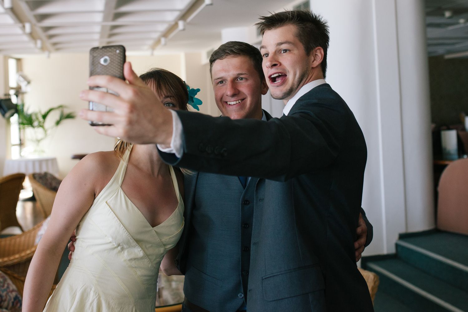Joyful candid moments shared between wedding guests during indoor celebration.