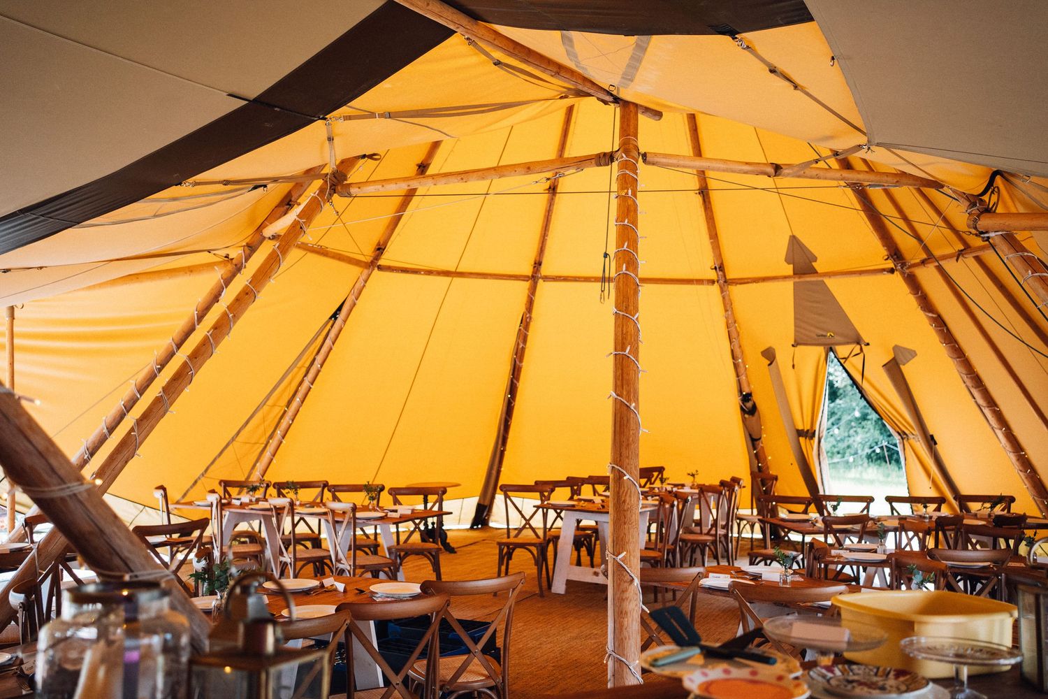 Warm glowing canopy of a large tent structure illuminated from within creating an amber-colored ceiling.