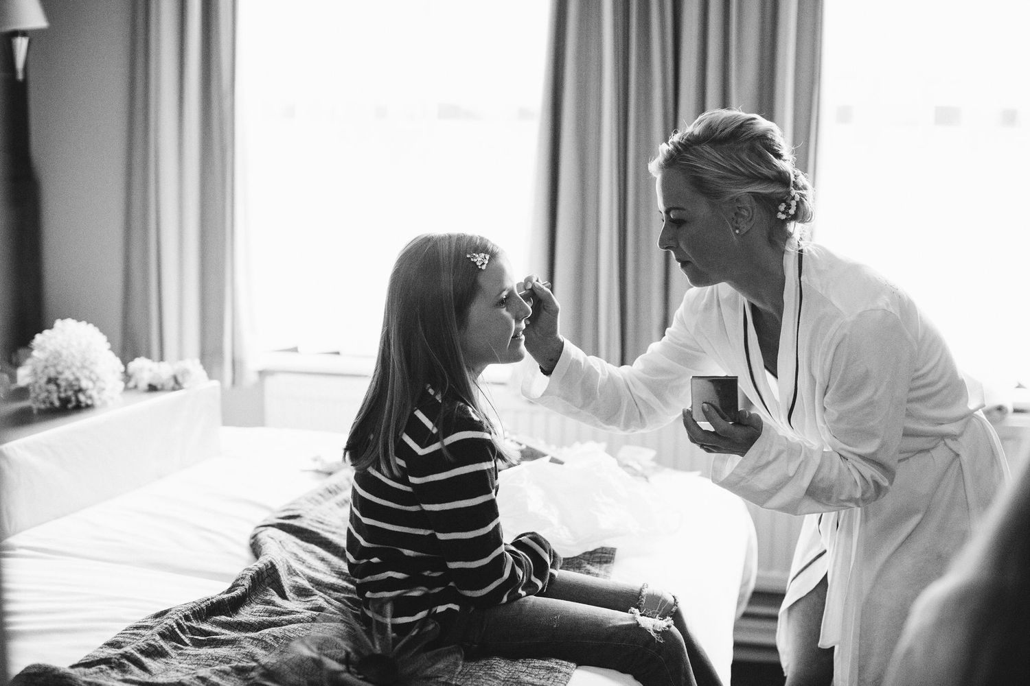 Candid black and white shots showing wedding preparation moments.