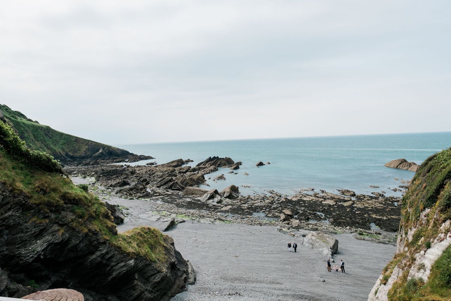 Scenic coastal landscape with rocky cliffs and ocean views along a winding path.