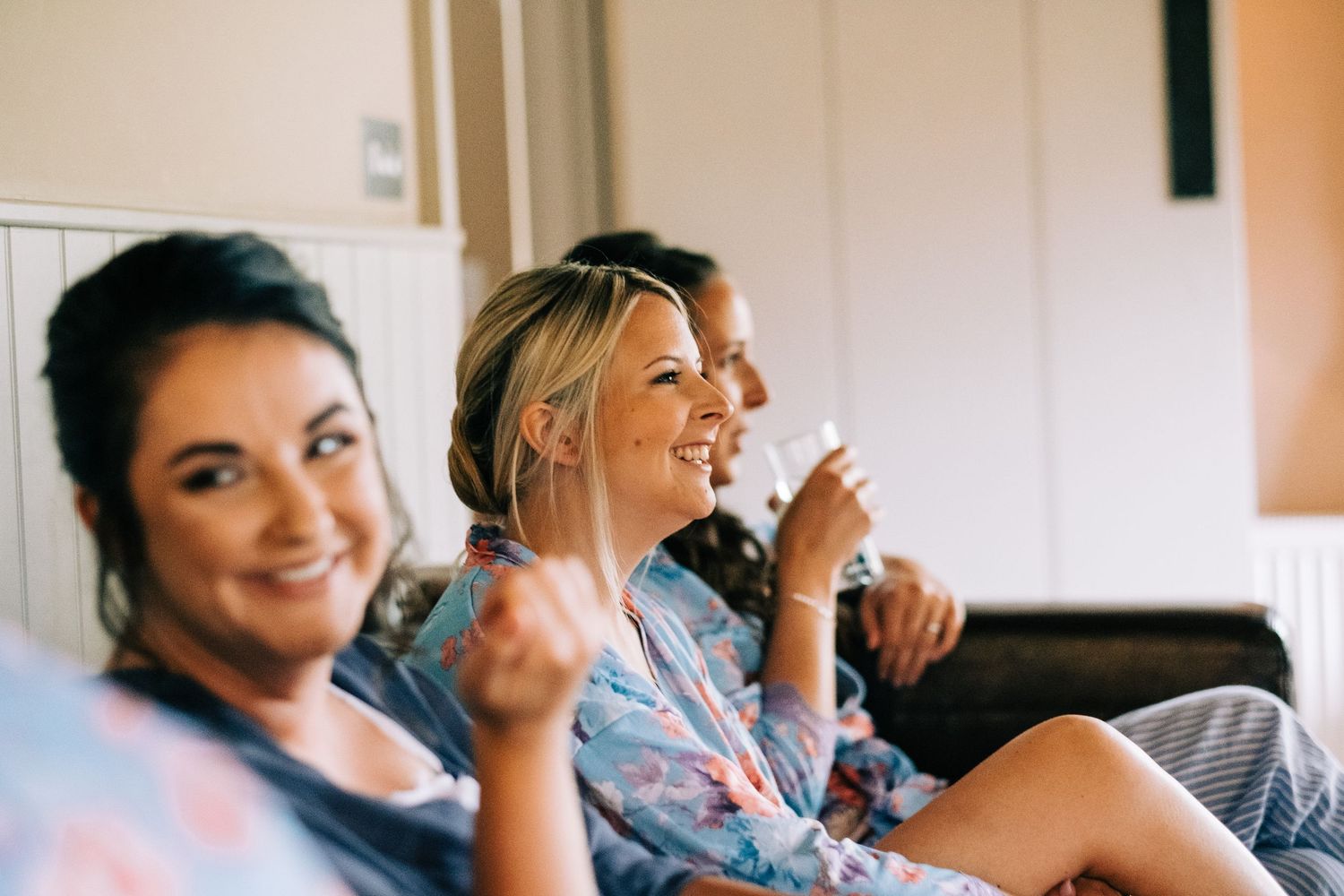 Group sharing joyful moments while getting ready in a bright room.