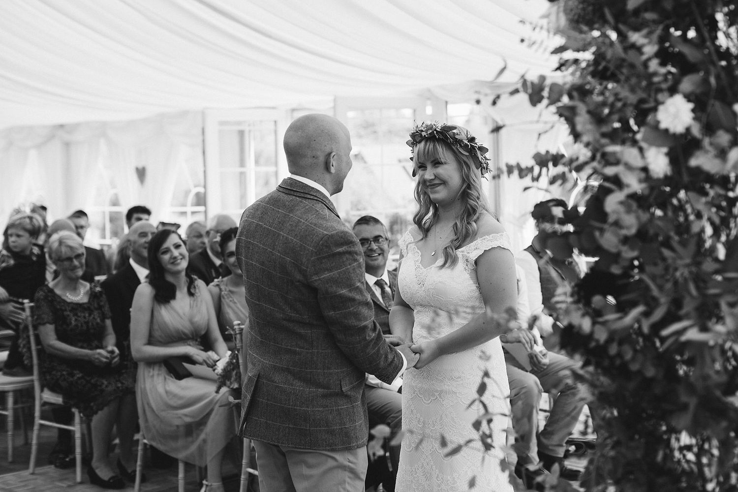 Candid wedding moments shared between guests during outdoor celebration.