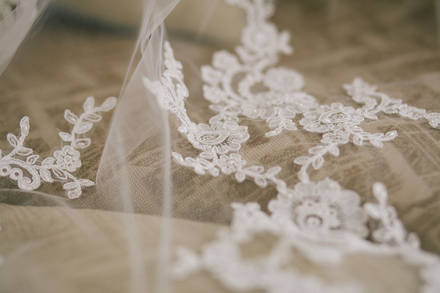 Delicate white lace details from a wedding dress in macro photography.