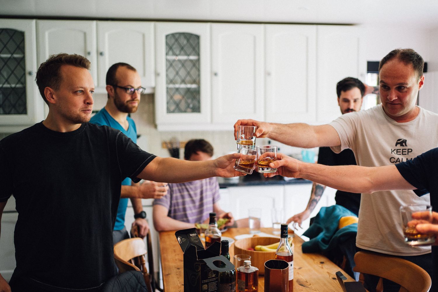 Friends sharing drinks and toasting at a casual gathering.