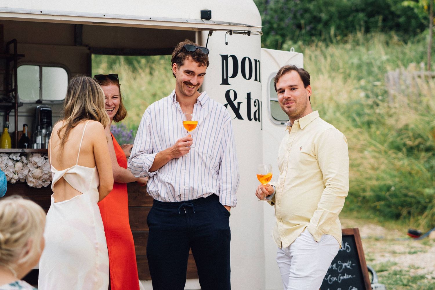 Vintage food truck parked outdoors during casual outdoor event.
