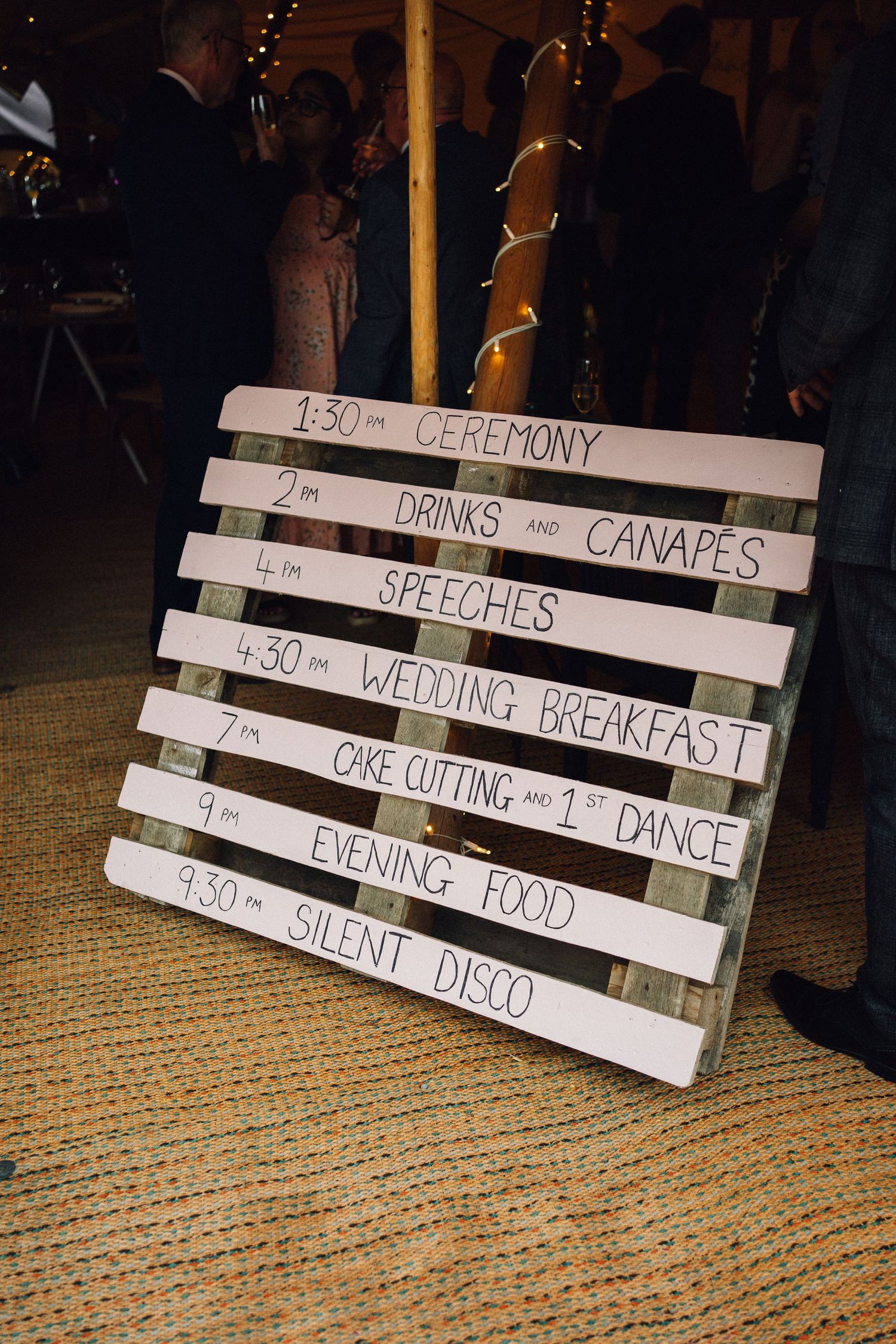 Wooden sign boards displaying wedding day timeline and event schedule.