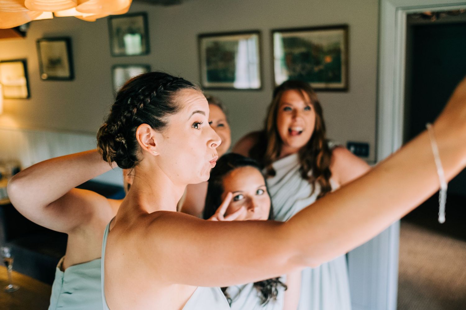 Group celebrating and dancing together in a casual indoor setting.