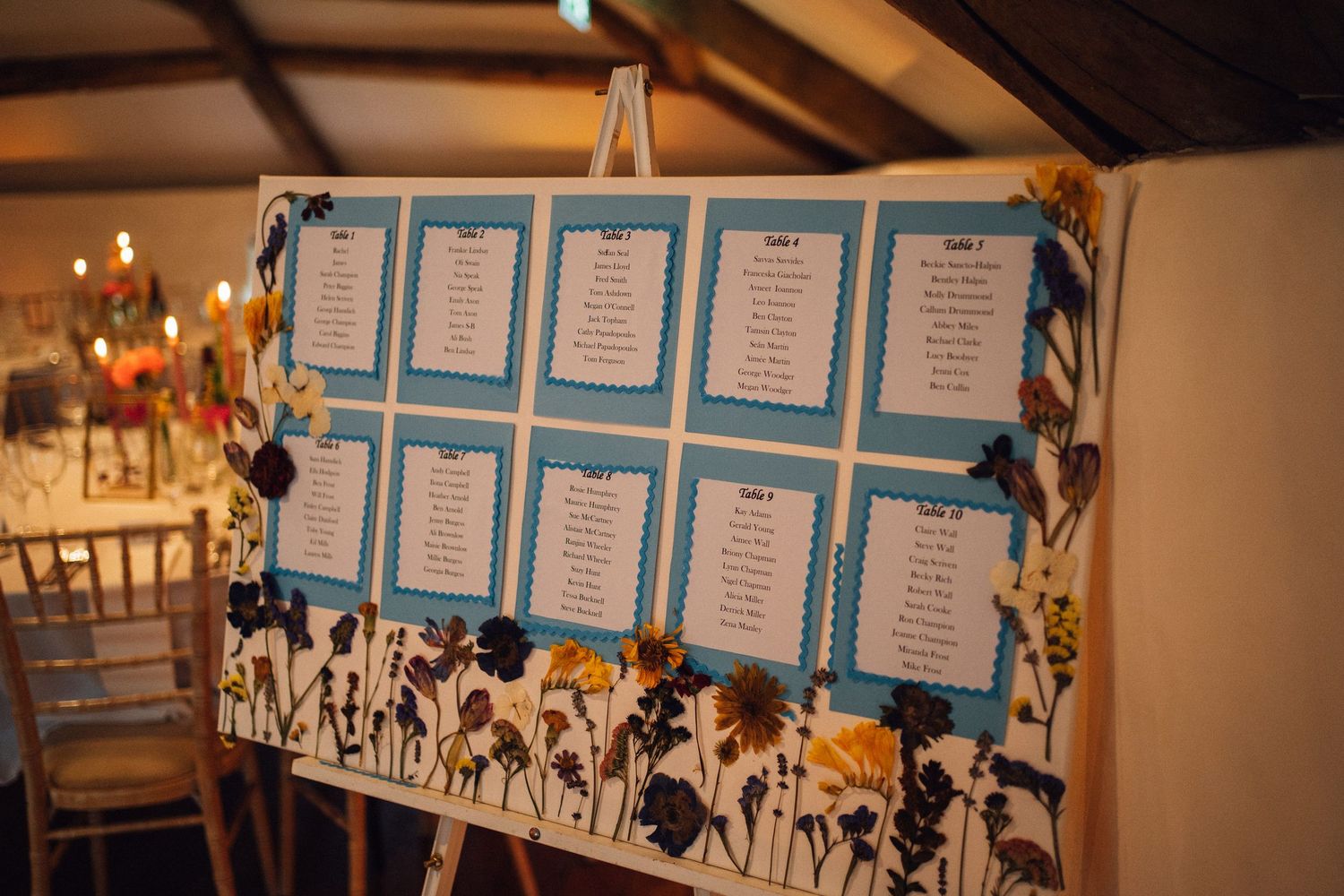 Wedding seating chart display with blue and white cards arranged in neat rows.