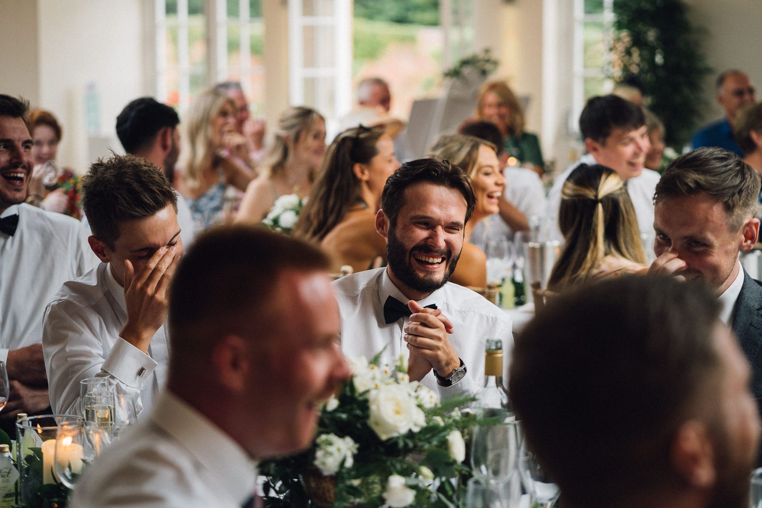 Wedding guests mingling and celebrating at an elegant indoor reception.