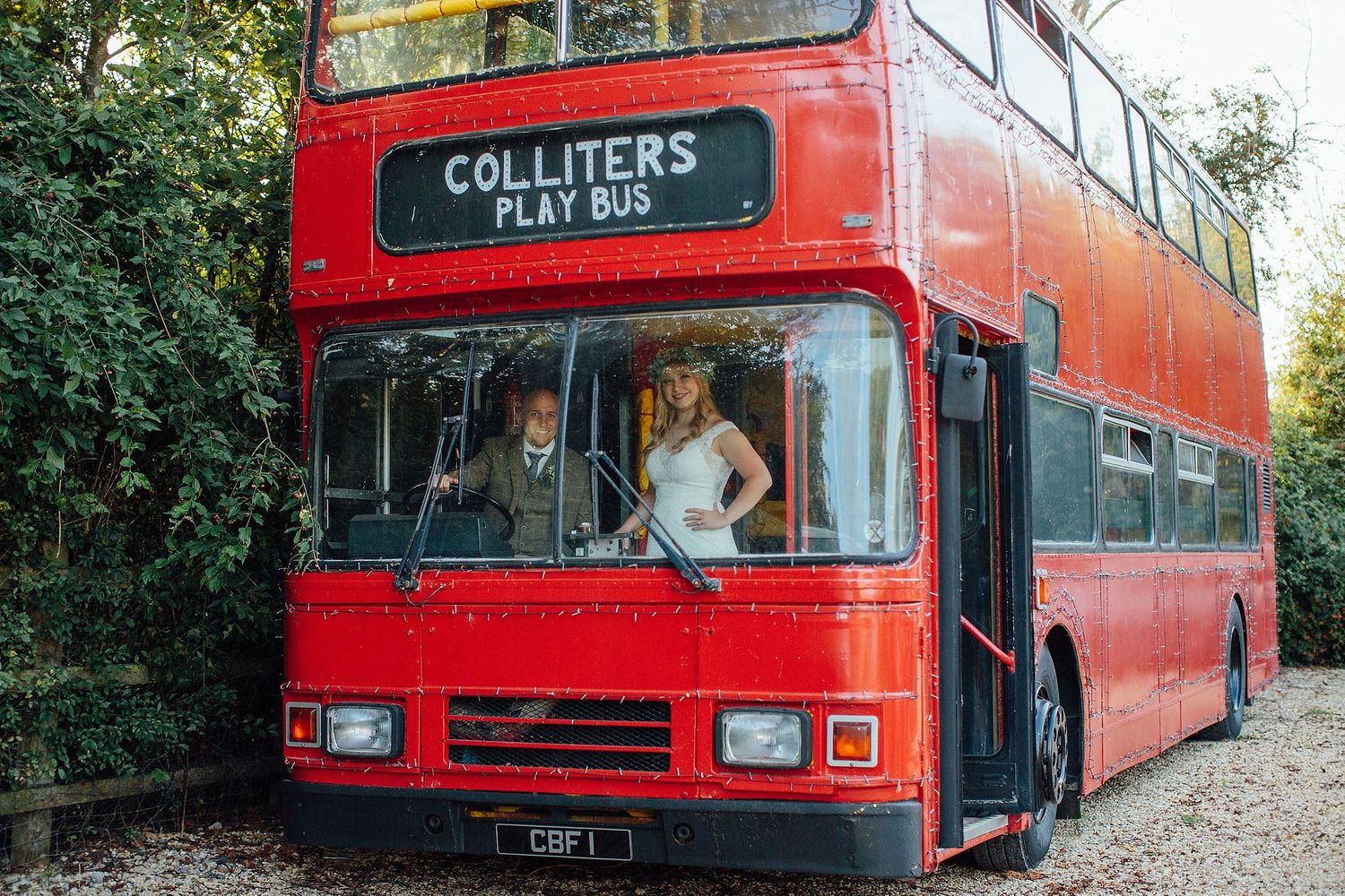 A vintage red double decker bus parked outdoors with Colliters signage visible.