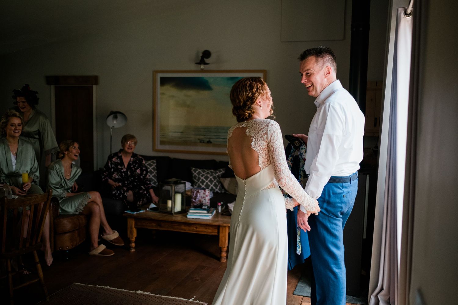 Joyful wedding day reactions captured in sequence during indoor first look.