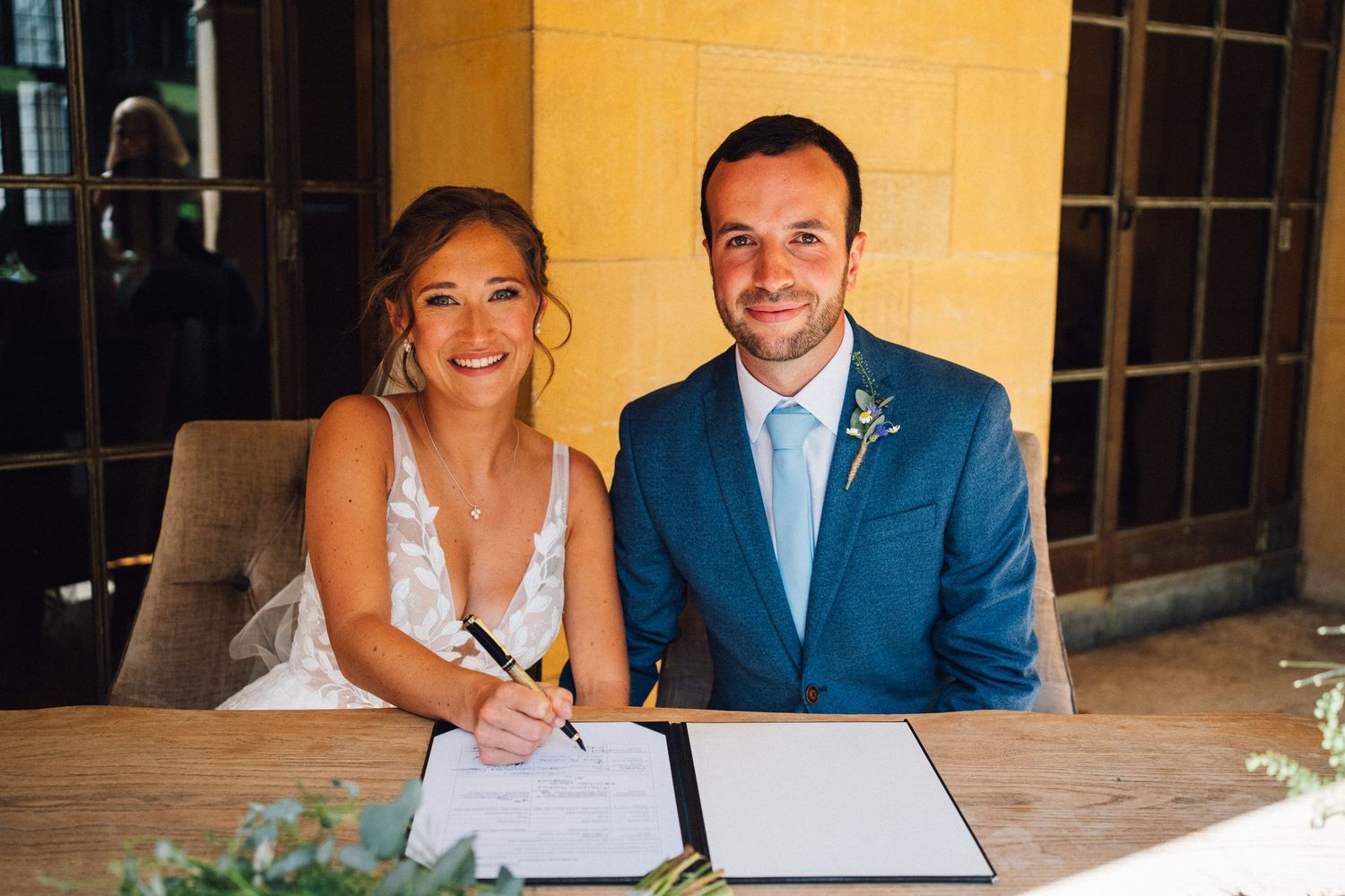 Wedding guests enjoying a candid moment at an elegant reception venue with warm lighting.