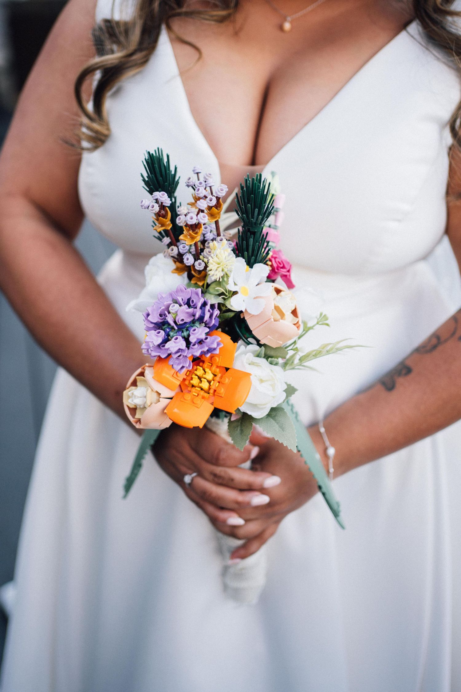 A series of wedding bouquets featuring colorful flowers and greenery held by someone wearing a white dress.