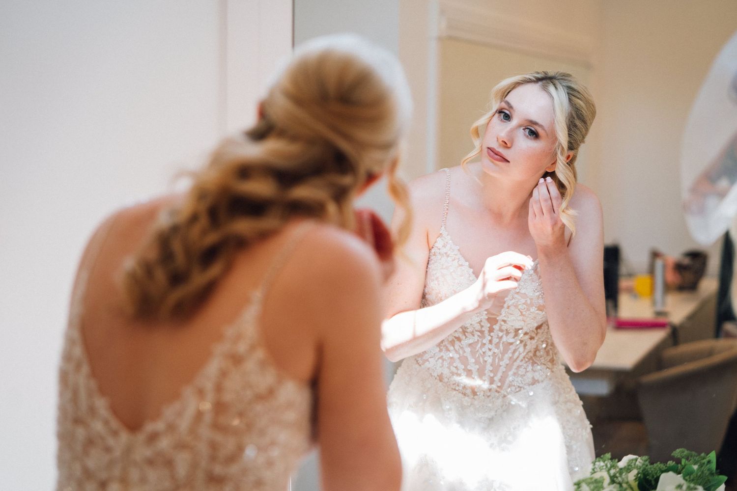 Wedding day preparation scenes showing final touches and adjustments in a bridal suite.