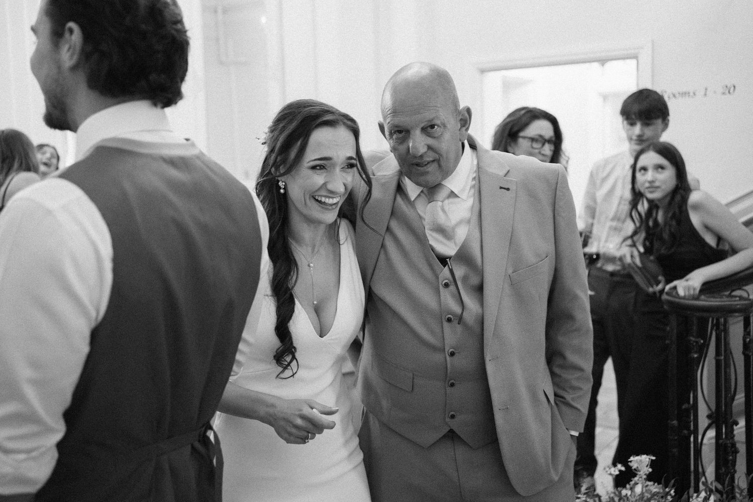 Wedding celebration candid moments in black and white during indoor reception.