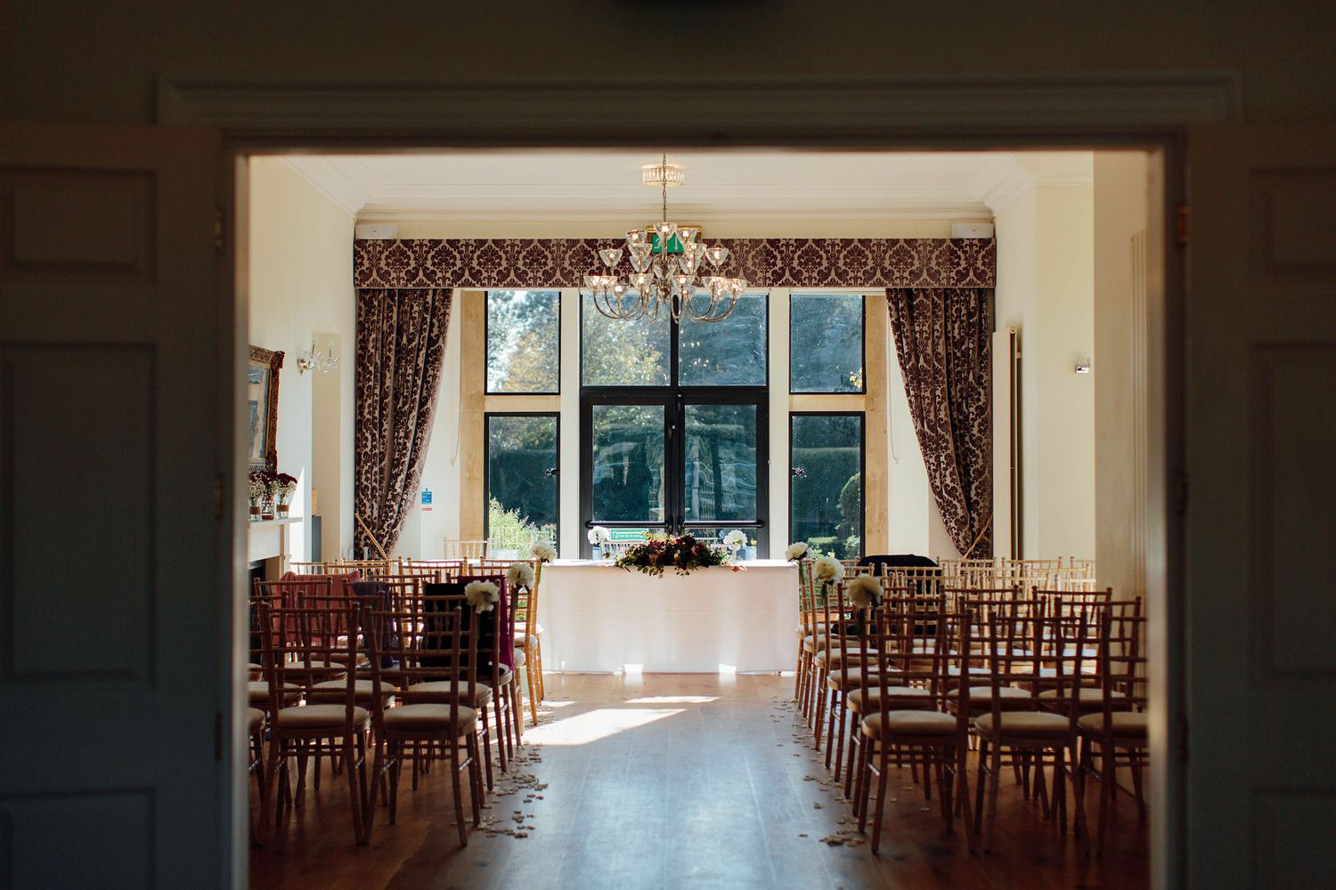 Empty wedding ceremony space with wooden chairs arranged in rows facing forward.