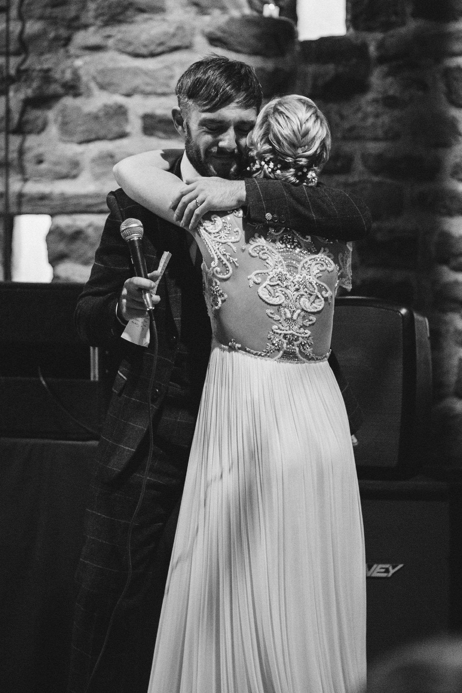 Wedding party members in formal attire performing during reception entertainment.