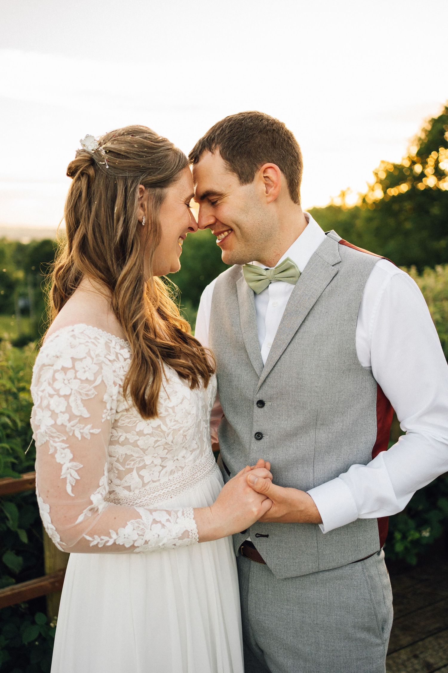 Intimate wedding portraits captured during golden hour with lace details and grey vest.